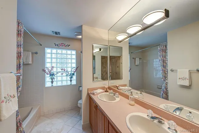 a bathroom with a sink double vanity and a mirror