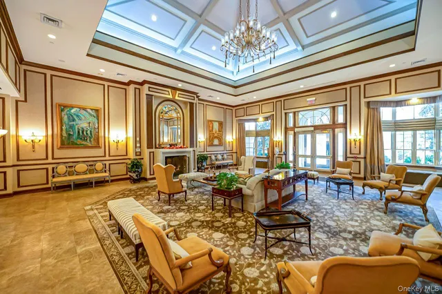 a living room with furniture chandelier and a large window