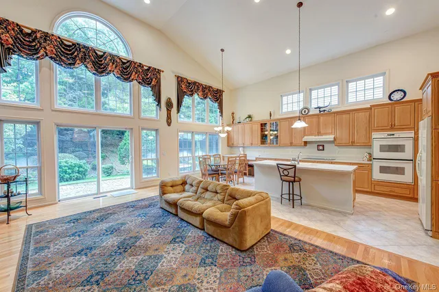 a very nice looking living room with a large window and a chandelier