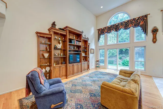 a living room with furniture a floor to ceiling window and couch