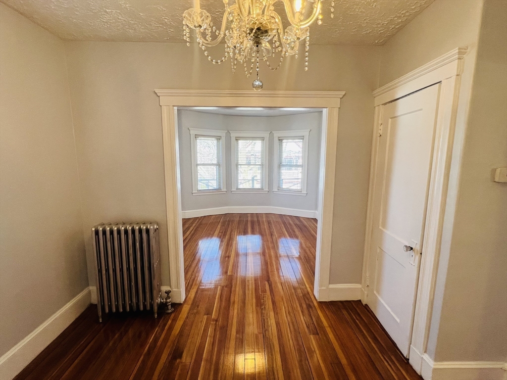 62 Westmore Road, Unit 2 Boston, MA 02126 - Photo 2 of 13 a view of front door with wooden floor