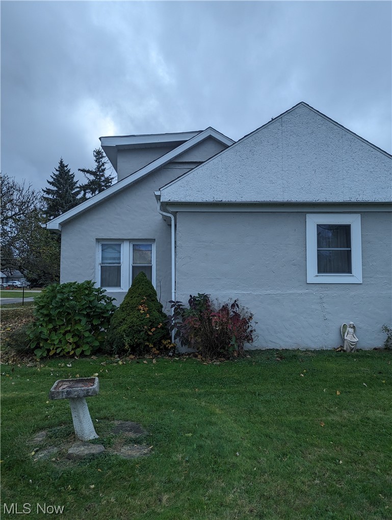 6948 Lake Road Madison, OH 44057 - Photo 1 of 16 View of home's exterior featuring a lawn