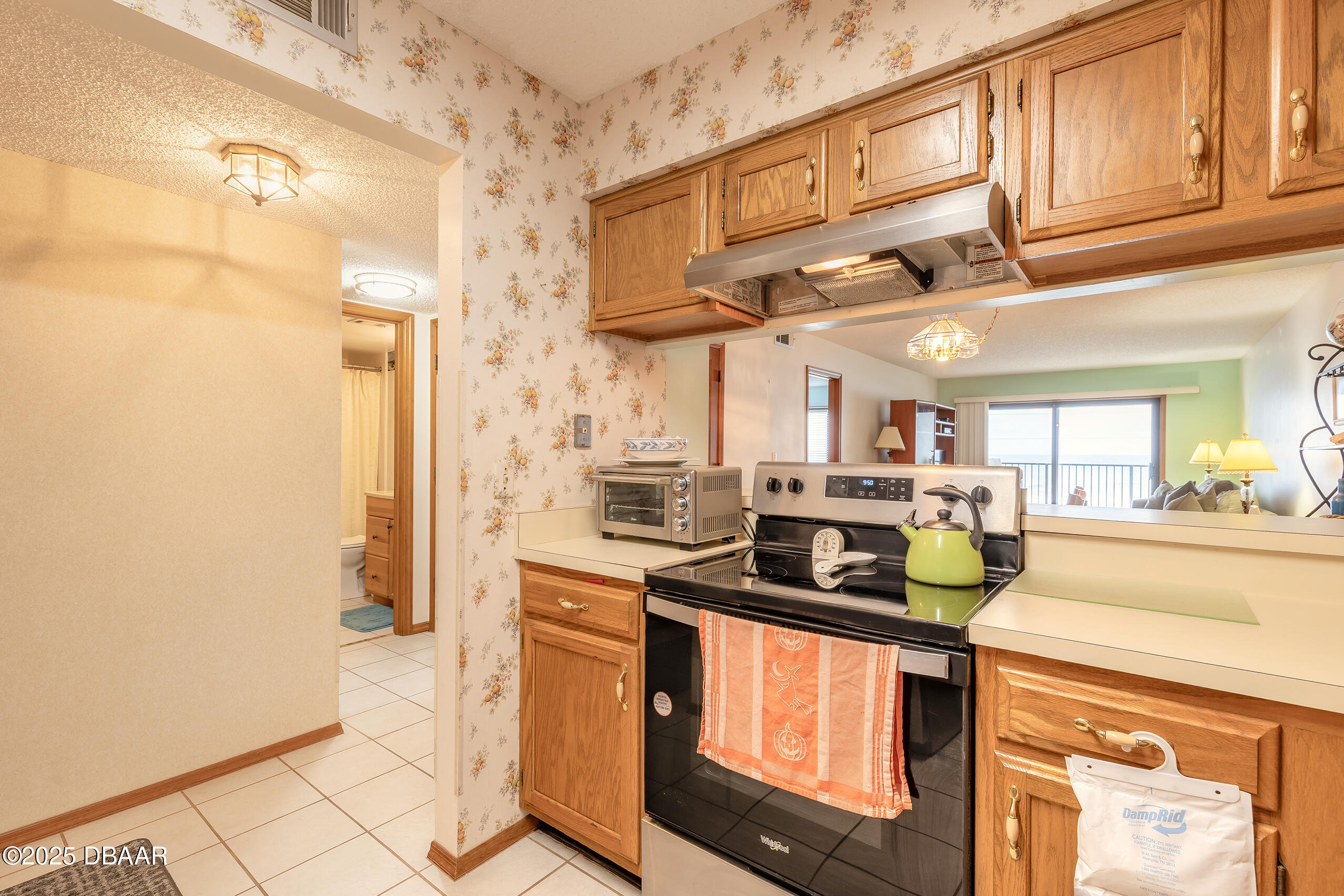 2222 Ocean Shore Boulevard, Unit 402B Ormond Beach, FL 32176 - Photo 15 of 31 a kitchen with stainless steel appliances granite countertop a sink and cabinets