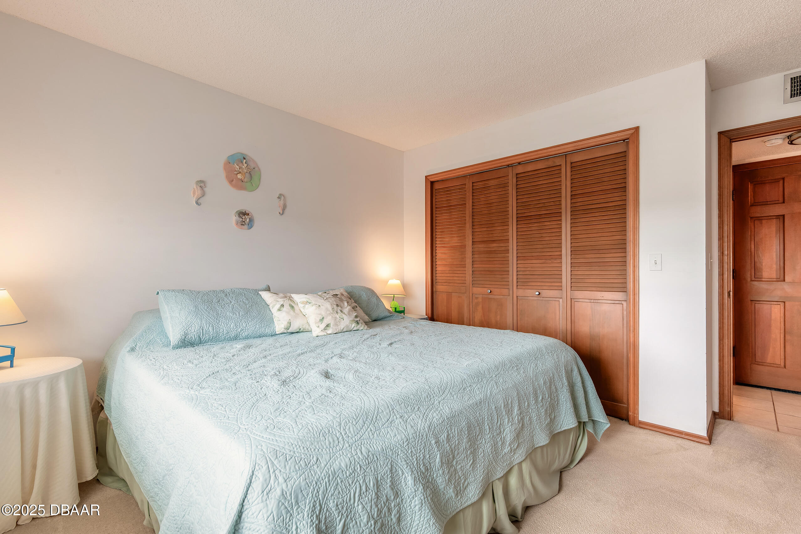2222 Ocean Shore Boulevard, Unit 402B Ormond Beach, FL 32176 - Photo 19 of 31 a bedroom with a bed and a window