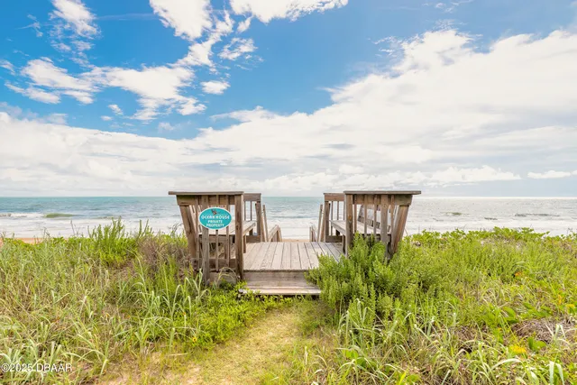 a view of a garden with lawn chairs