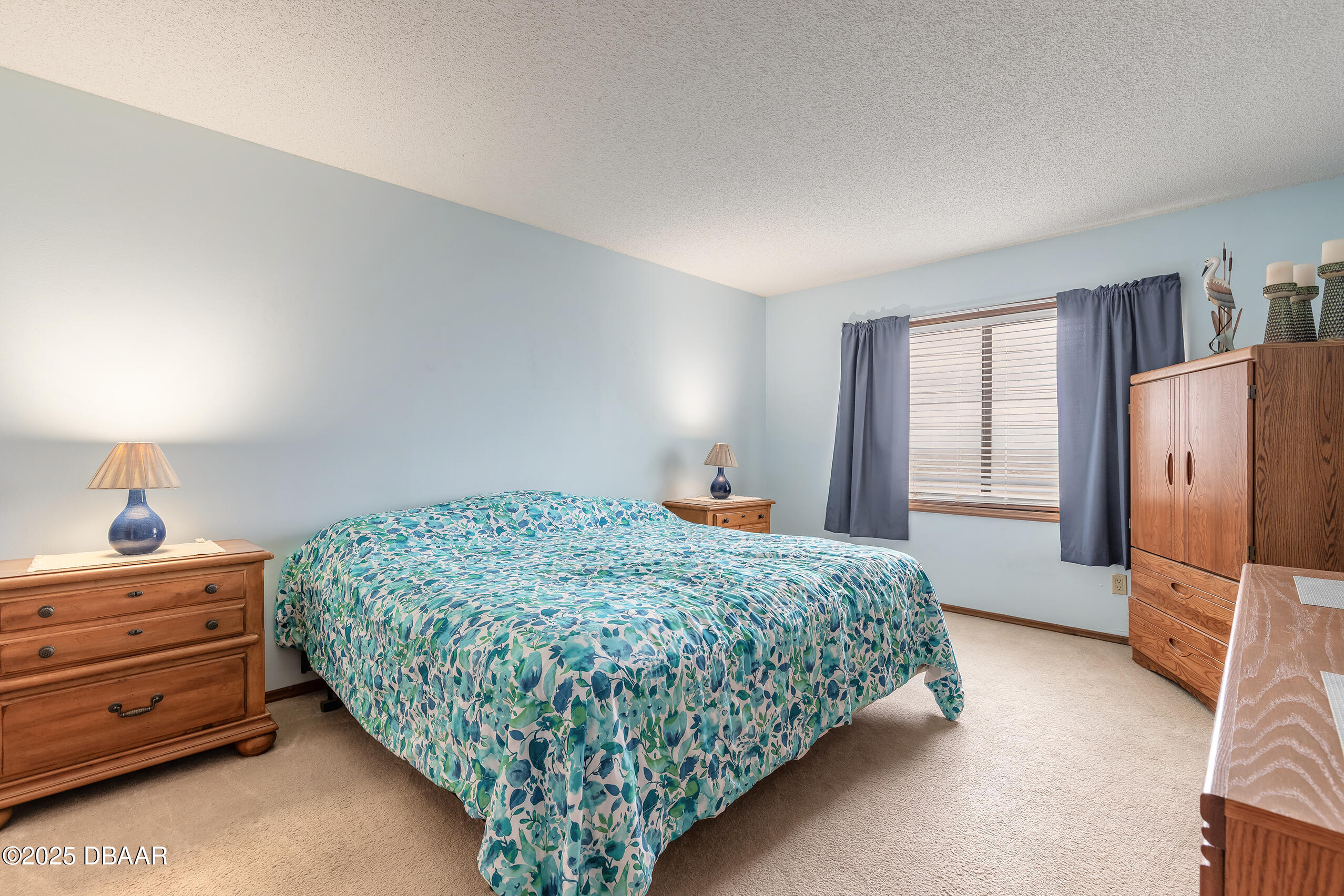 2222 Ocean Shore Boulevard, Unit 402B Ormond Beach, FL 32176 - Photo 21 of 31 a bedroom with a bed and a window