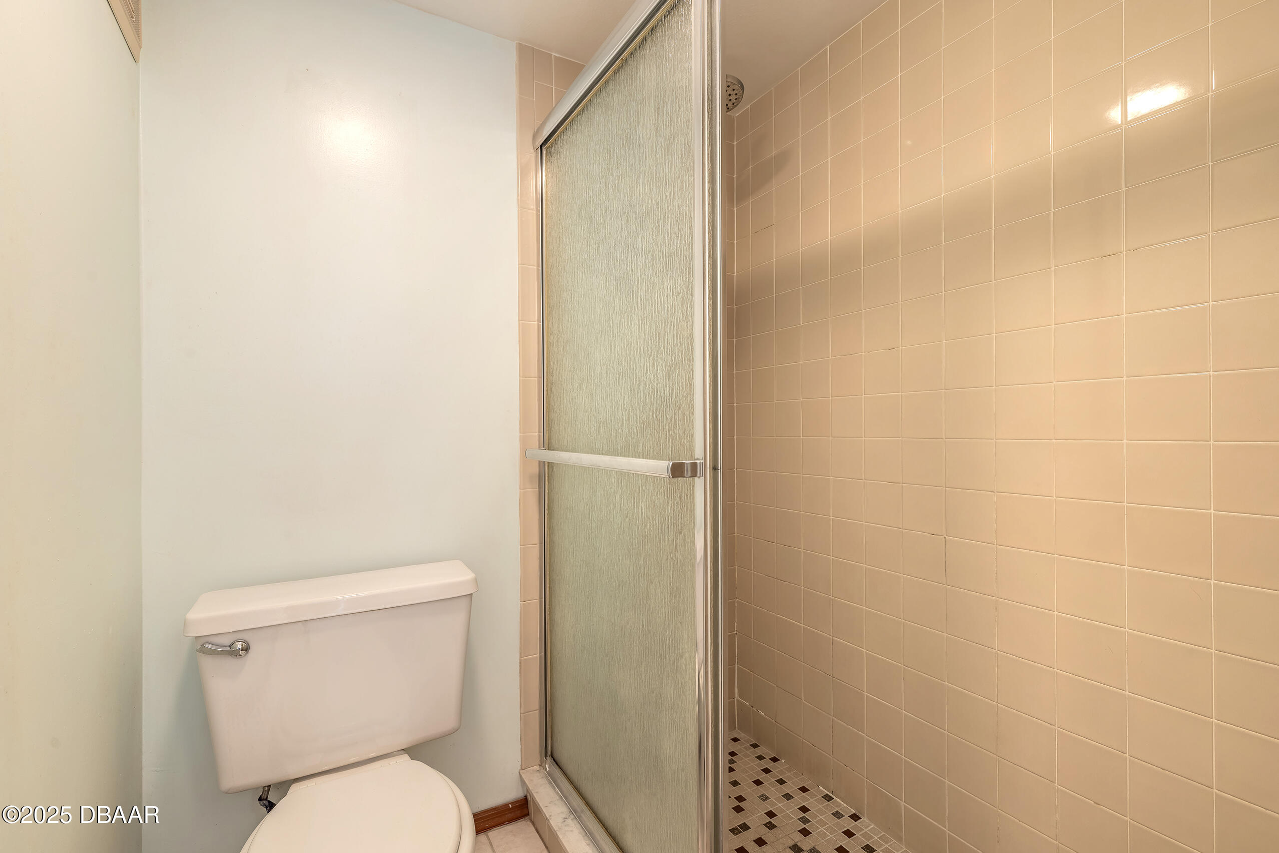 2222 Ocean Shore Boulevard, Unit 402B Ormond Beach, FL 32176 - Photo 24 of 31 a white toilet sitting next to a shower