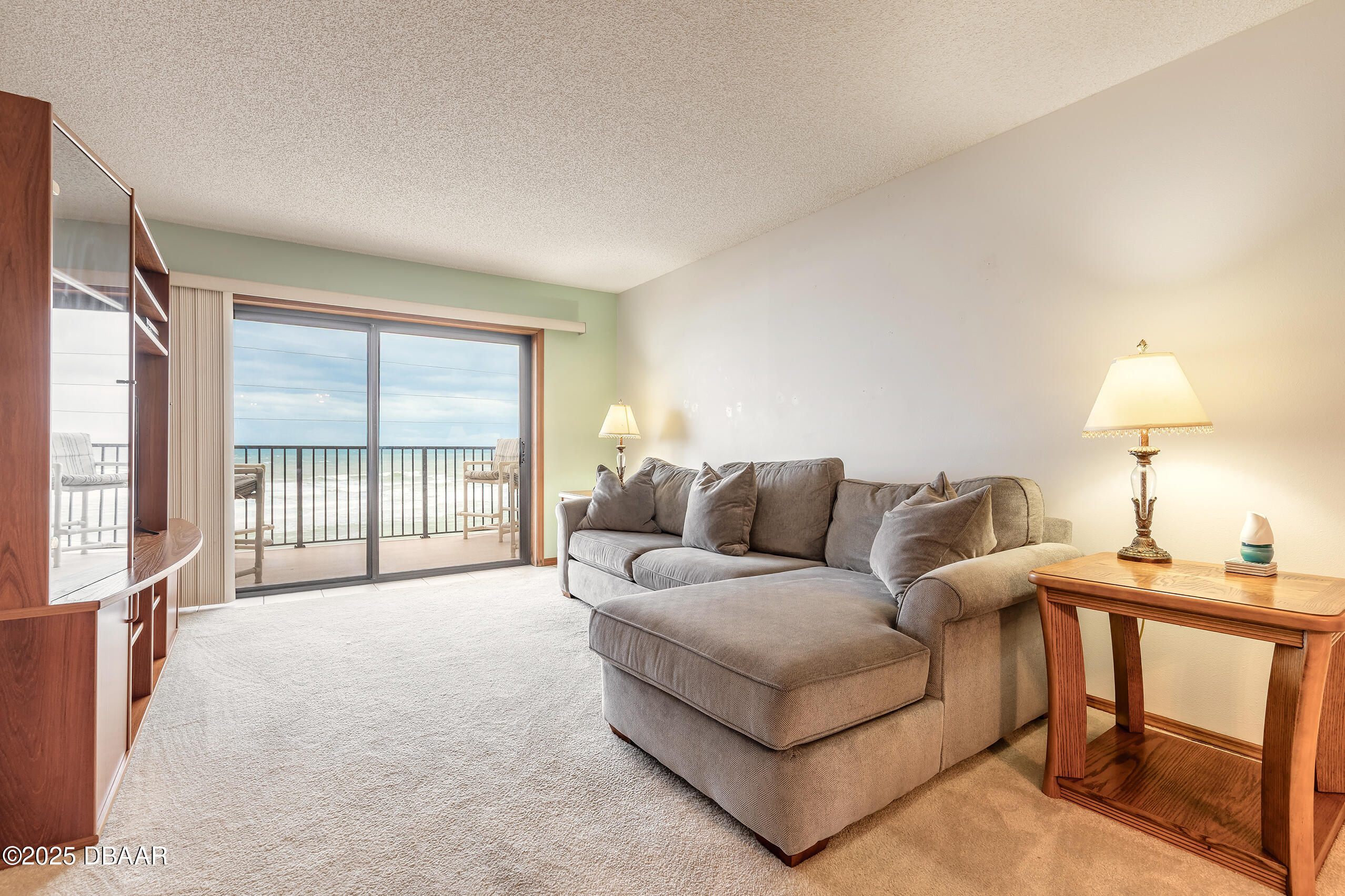 2222 Ocean Shore Boulevard, Unit 402B Ormond Beach, FL 32176 - Photo 25 of 31 a living room with furniture and a window