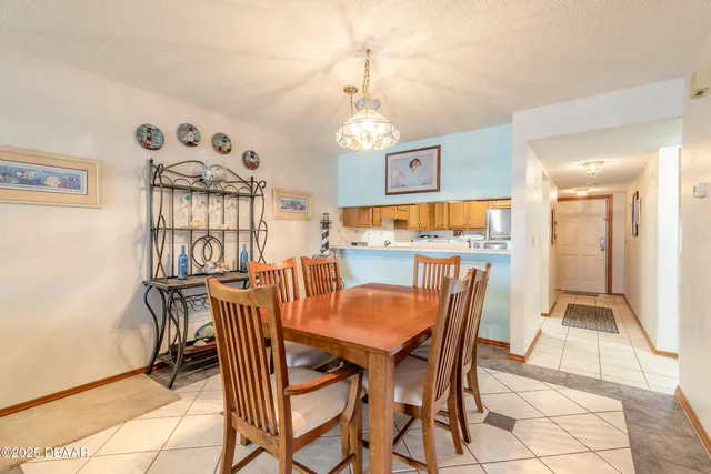 a view of a dining room with furniture wooden floor and a chandelier