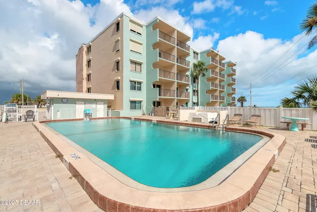 a view of swimming pool with outdoor seating