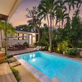 a view of swimming pool with outdoor seating and plants