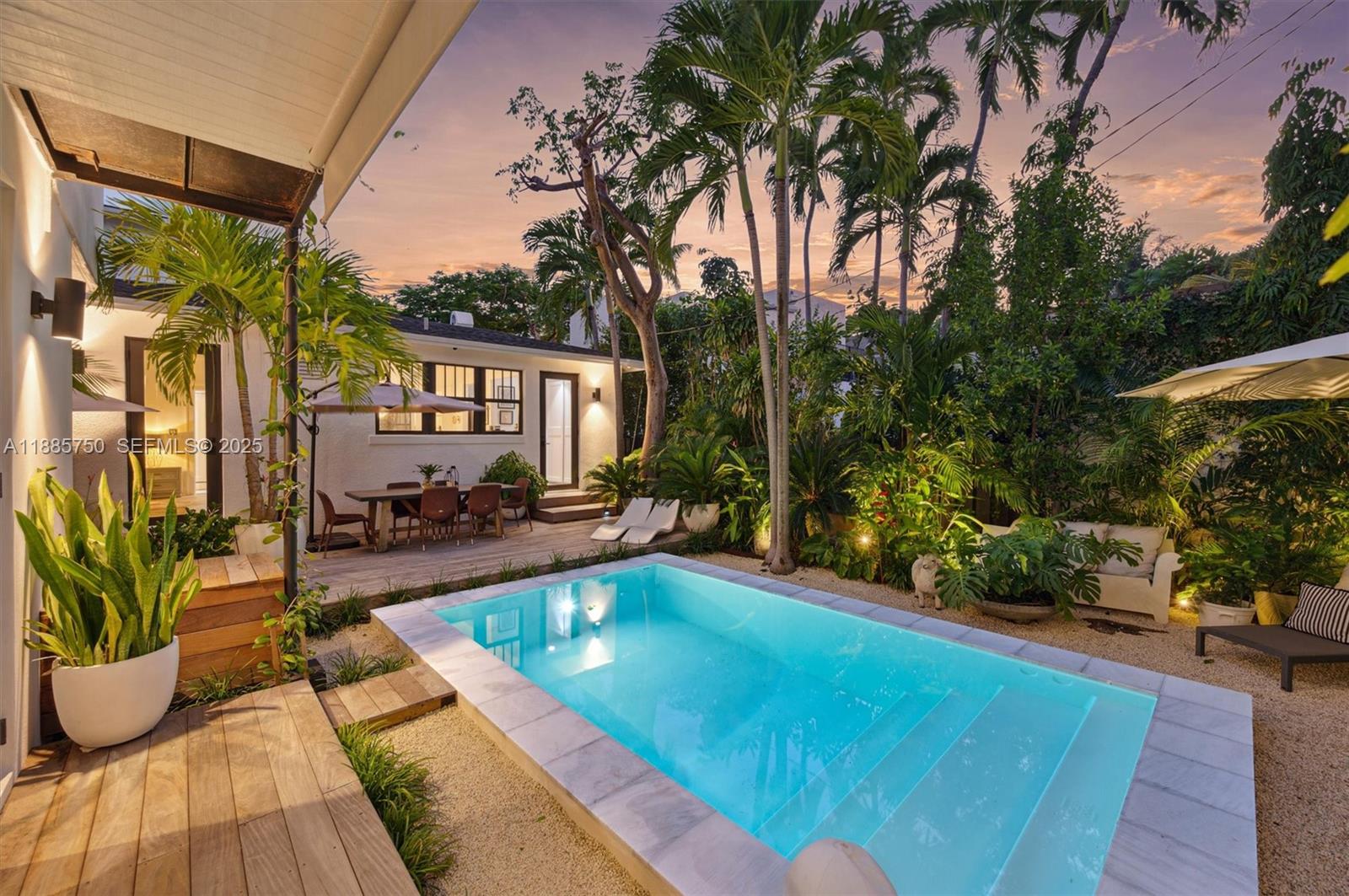 a view of swimming pool with outdoor seating and plants