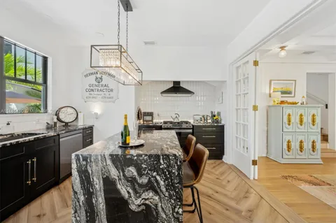 a kitchen with stainless steel appliances granite countertop a sink and cabinets