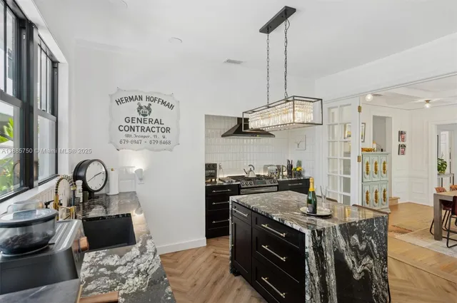 a kitchen with stainless steel appliances granite countertop a stove a sink and a refrigerator
