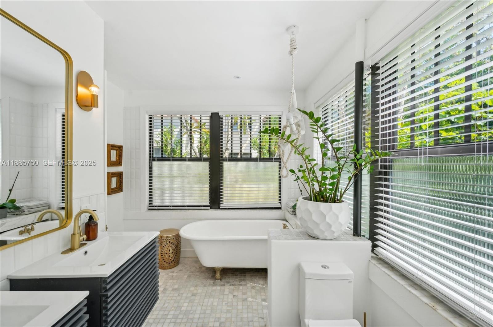 135 Northeast 45th Street Miami, FL 33137 - Photo 21 of 48 a bathroom with a tub sink and mirror