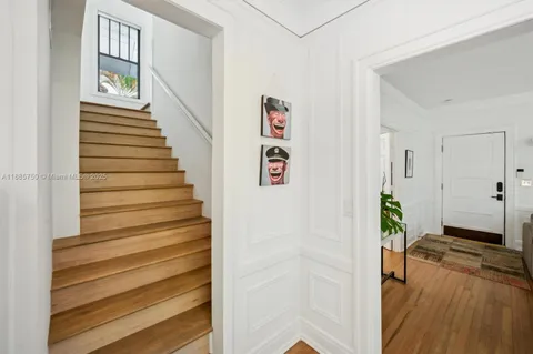 a view of a hallway with wooden floor and entryway