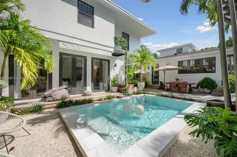 a view of a house with backyard and sitting area