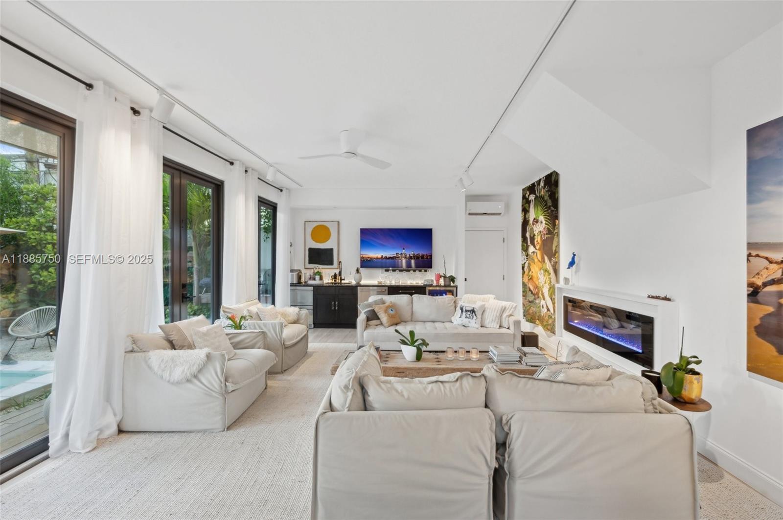 135 Northeast 45th Street Miami, FL 33137 - Photo 34 of 48 a living room with furniture and a flat screen tv