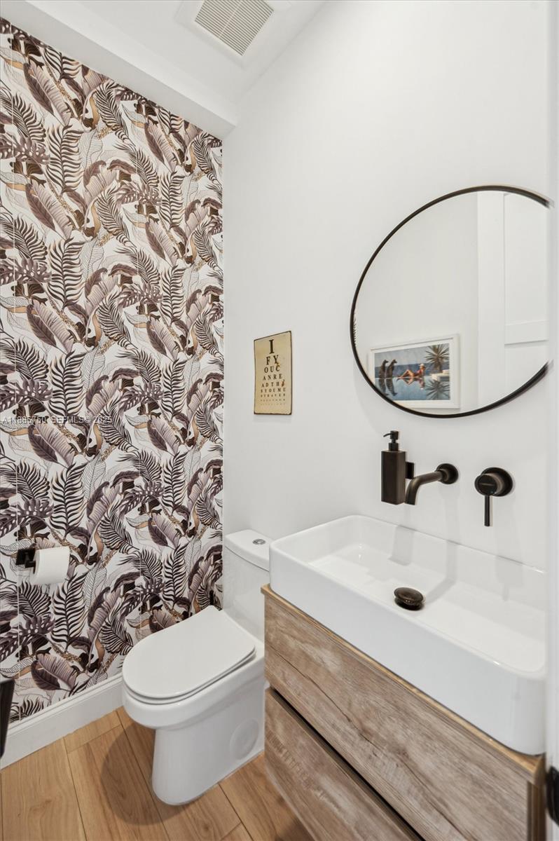 135 Northeast 45th Street Miami, FL 33137 - Photo 36 of 48 a bathroom with a sink and a mirror