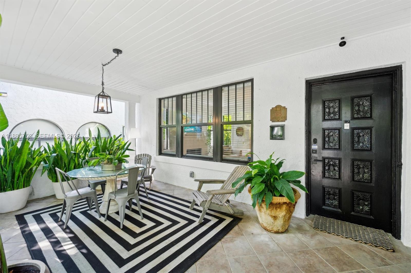 135 Northeast 45th Street Miami, FL 33137 - Photo 4 of 48 a vase of flowers sitting on a table in front of a window