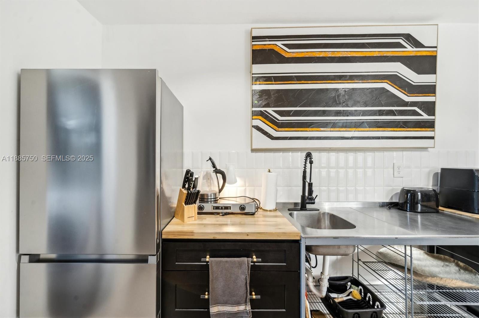 135 Northeast 45th Street Miami, FL 33137 - Photo 41 of 48 a kitchen with a refrigerator and a sink