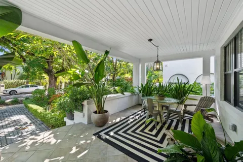 a view of a chairs and table in patio with potted plants