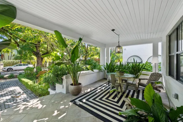 a view of a chairs and table in patio with potted plants