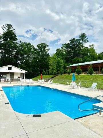 a view of a swimming pool with a yard