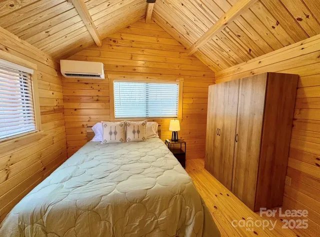 a large bed sitting in a bedroom next to a window