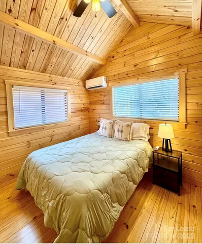 a bed sitting in a bedroom next to a window