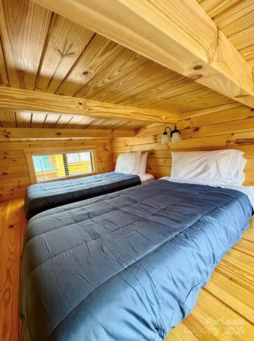 a bedroom with a bed and a night stand