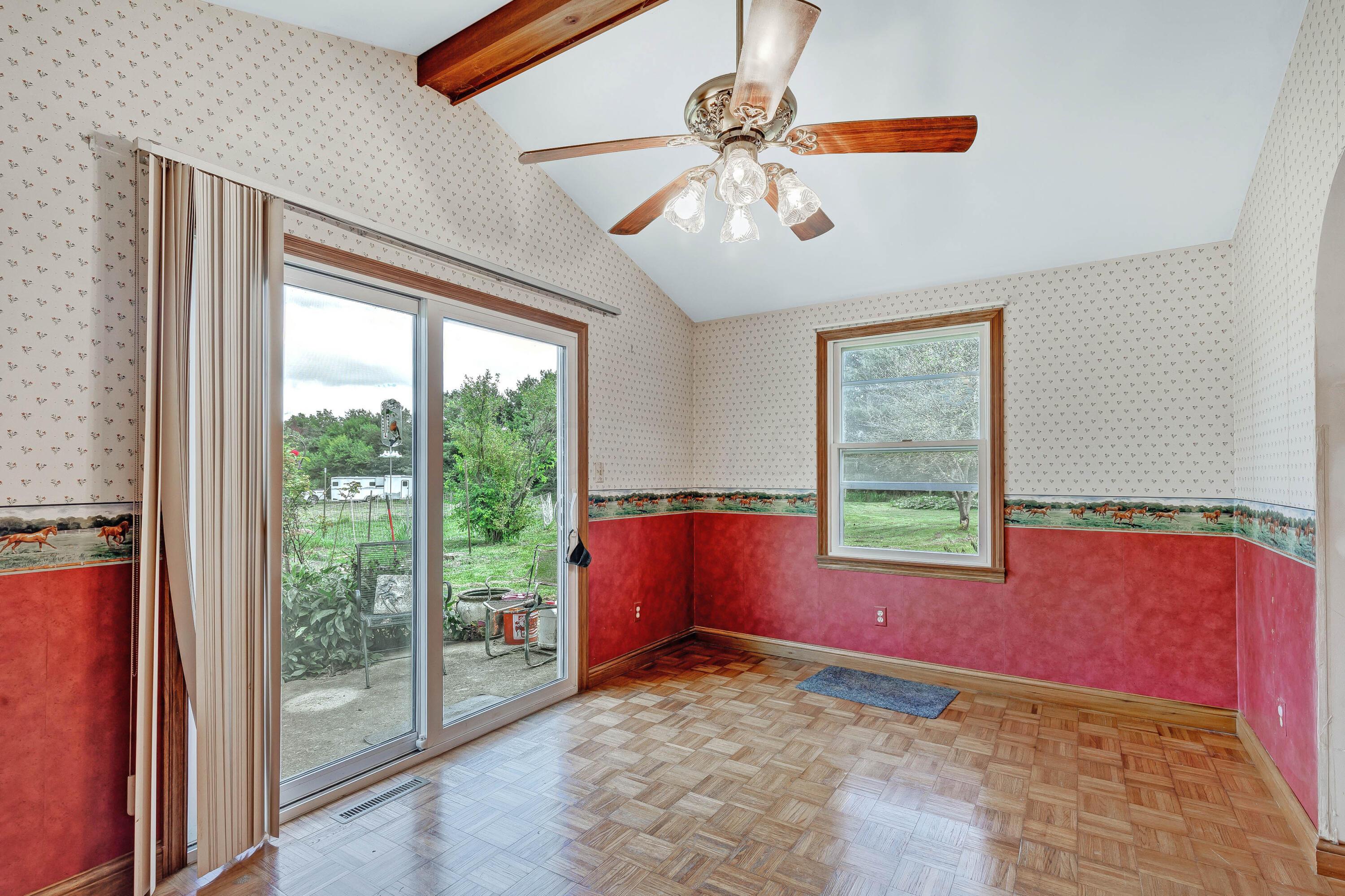 8558 Morris Road Hilliard, OH 43026 - Photo 24 of 74 • Parquet wood flooring • Papered walls • Cathedral ceiling • Decorative ceiling beams • Lighted ceiling fan • New double sliding doors to patio ~2021