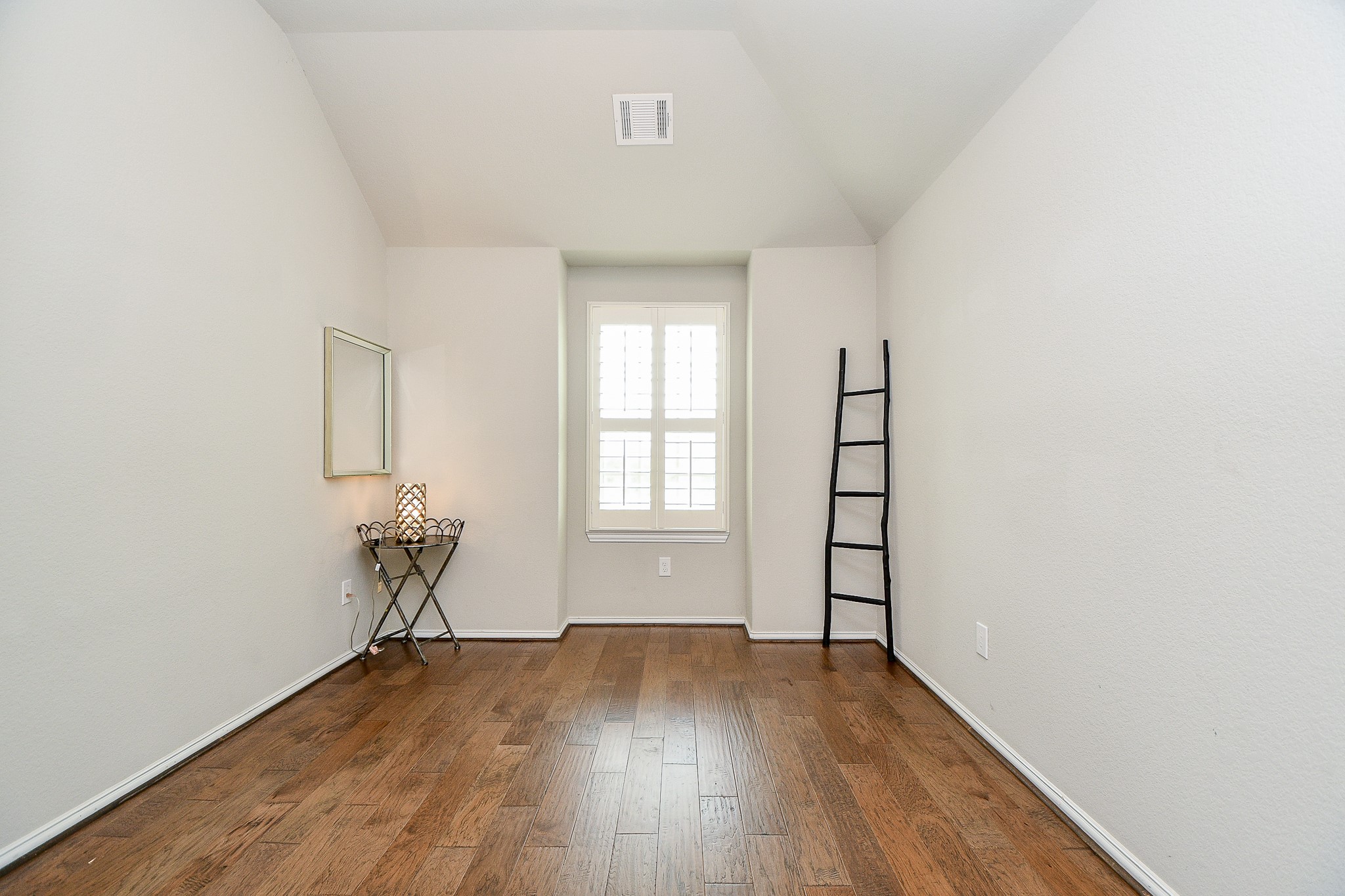 4523 Juniper Ridge Lane Manvel, TX 77578 - Photo 29 of 38 an empty room with wooden floor and windows