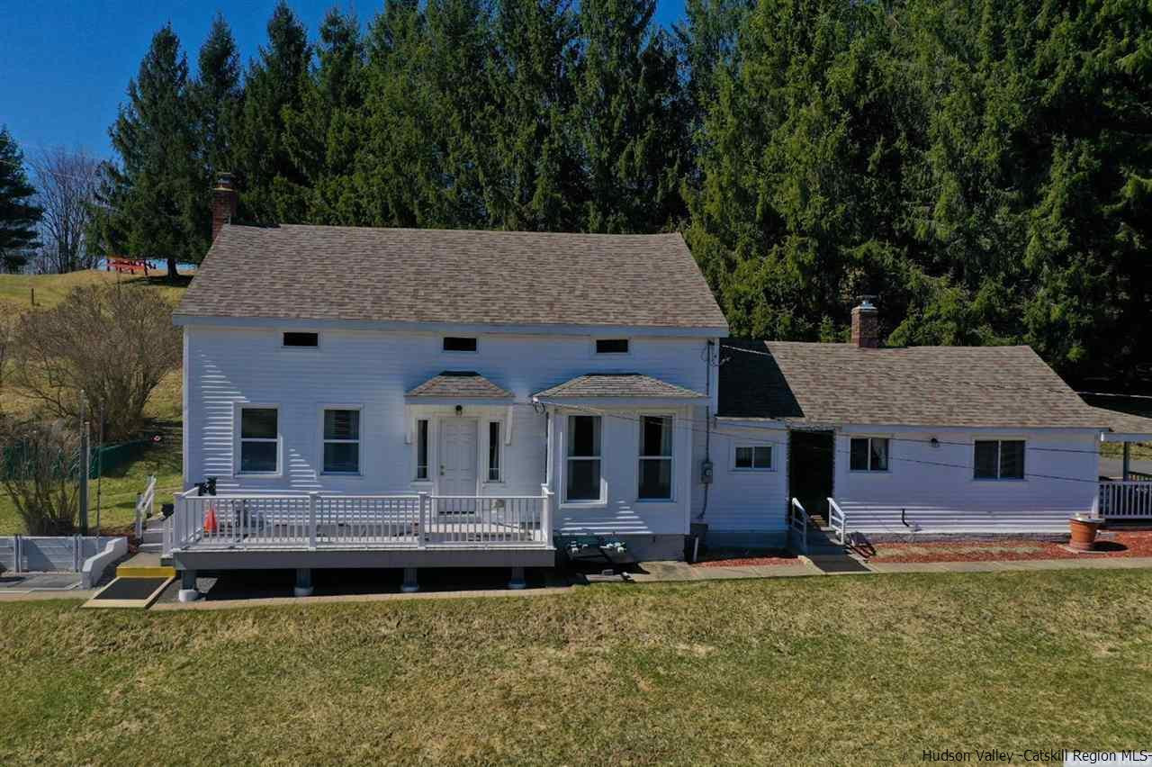a front view of a house with a yard table and chairs