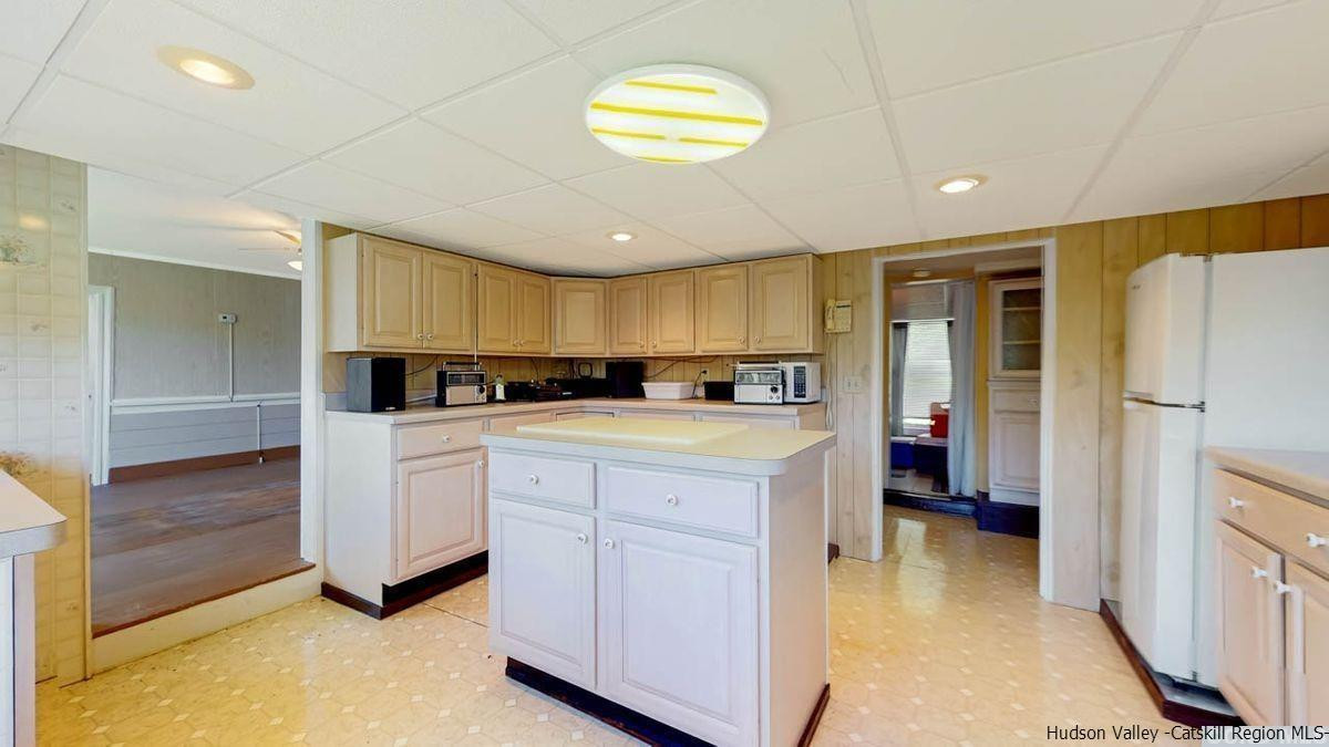 53 Pine Valley Road Greenville, NY 12083 - Photo 8 of 35 a kitchen with cabinets and a refrigerator