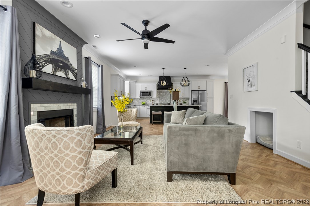 141 Sears Drive Cameron, NC 28326 - Photo 13 of 27 a living room with furniture a fireplace and a flat screen tv