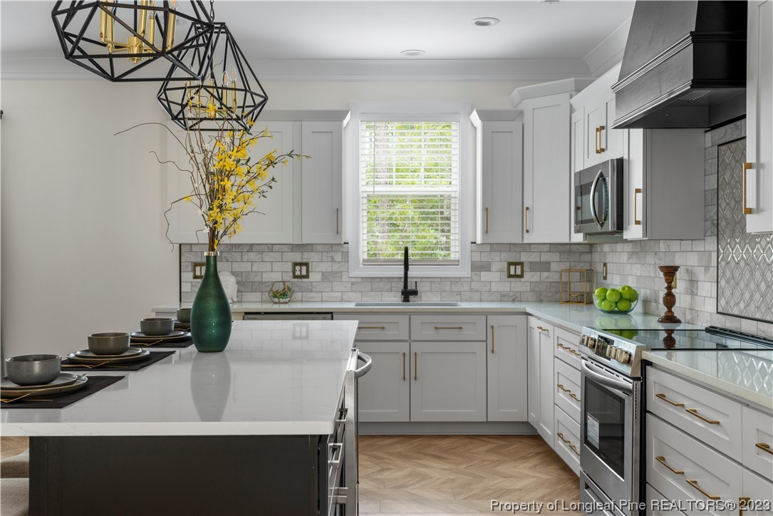 141 Sears Drive Cameron, NC 28326 - Photo 16 of 27 a kitchen with a sink stove and cabinets