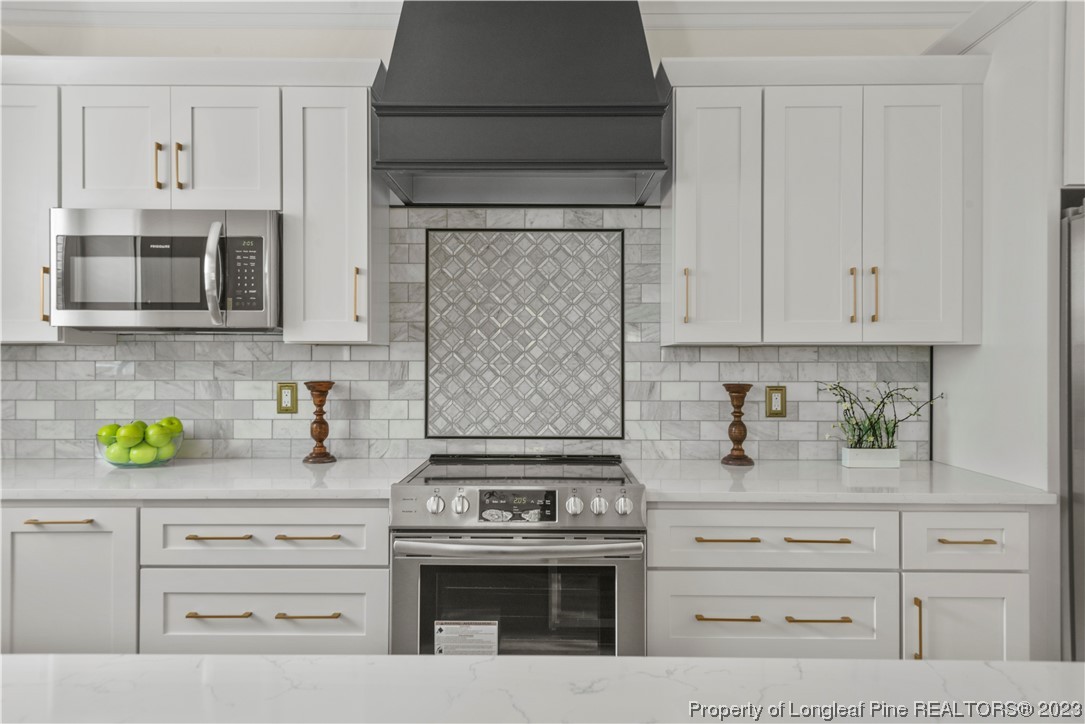 141 Sears Drive Cameron, NC 28326 - Photo 17 of 27 a kitchen with white cabinets and appliances