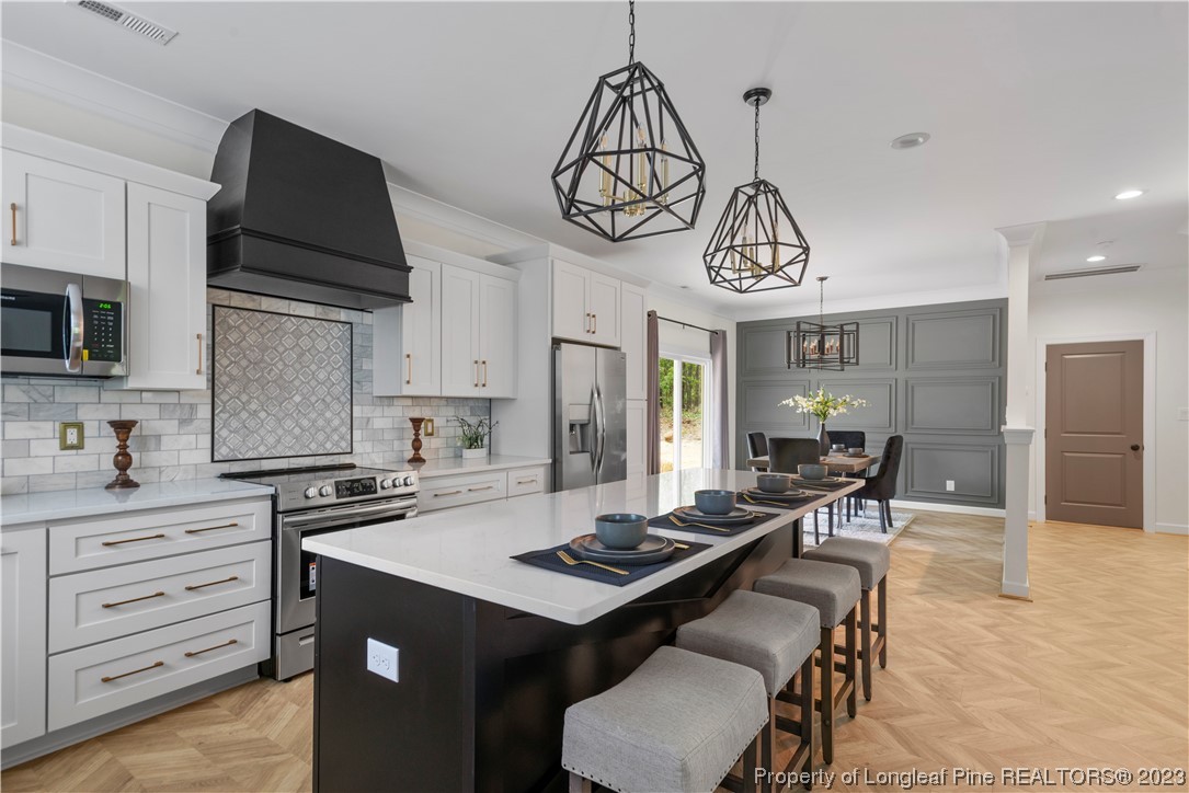 141 Sears Drive Cameron, NC 28326 - Photo 18 of 27 a kitchen with granite countertop a sink a stove and cabinets