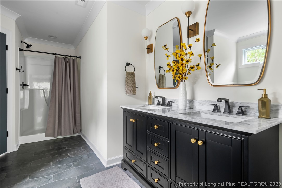 141 Sears Drive Cameron, NC 28326 - Photo 22 of 27 a bathroom with a double vanity sink and mirror