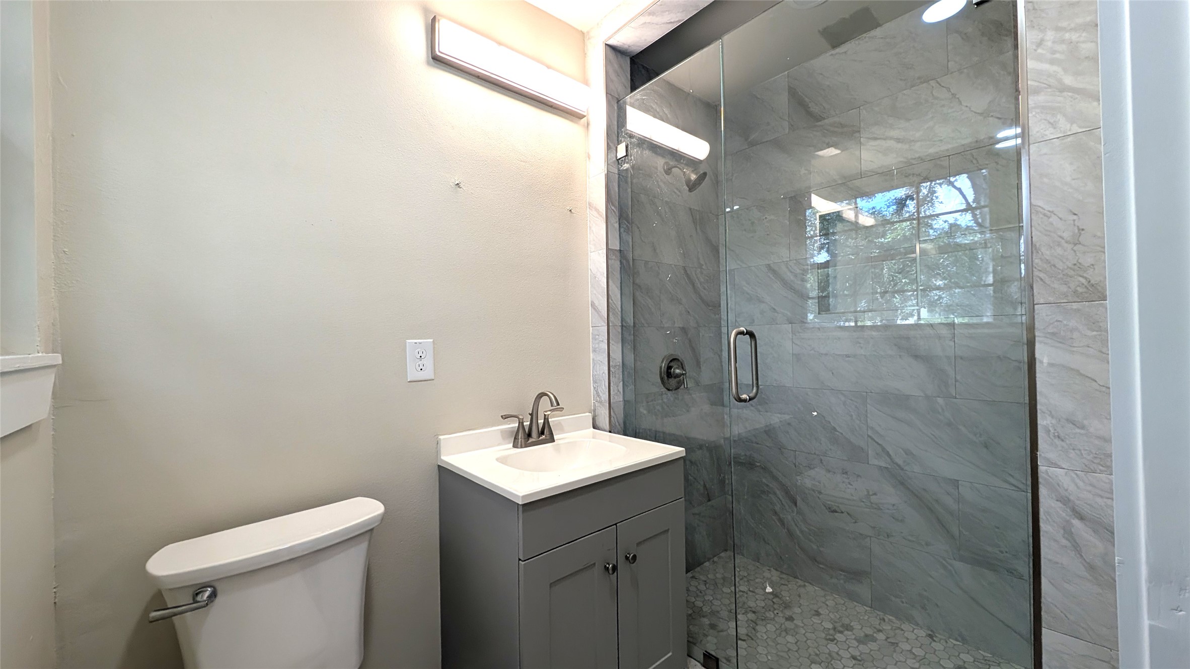 11811 Sleepy Hollow Road Manchaca, TX 78652 - Photo 15 of 31 a bathroom with a sink a toilet and shower