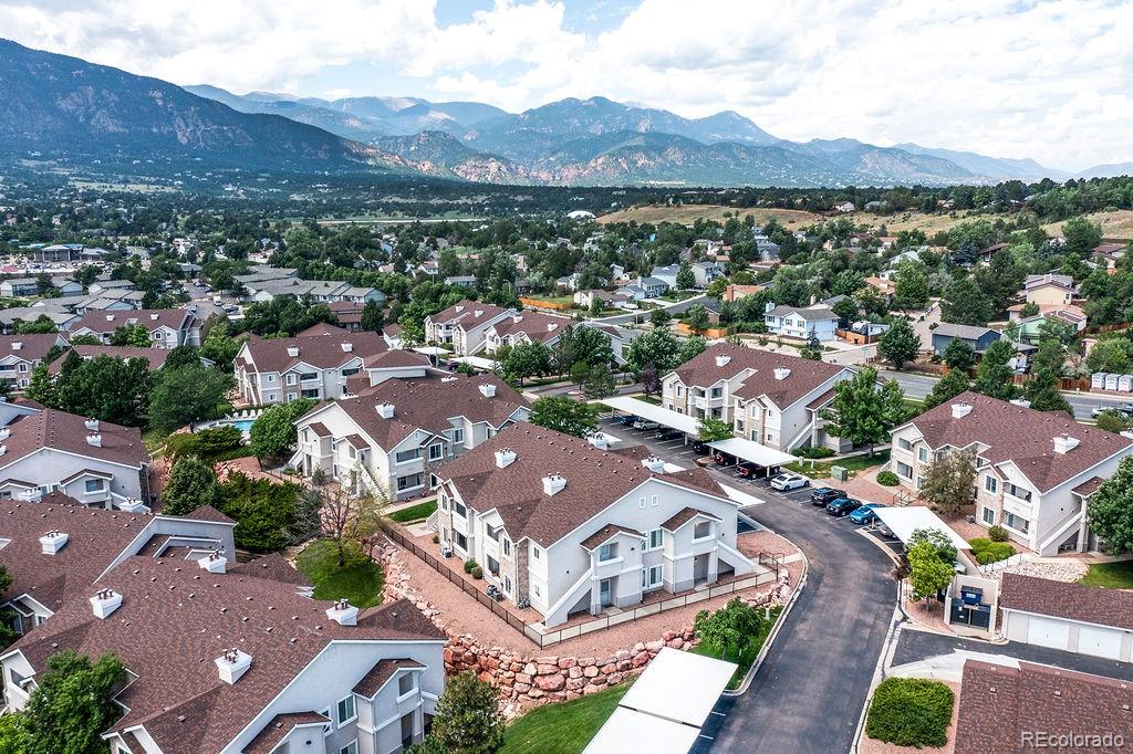 3875 Strawberry Field Grove Colorado Springs, CO 80906 - Photo 17 of 50 an aerial view of a city with lots of residential buildings and mountain view in back