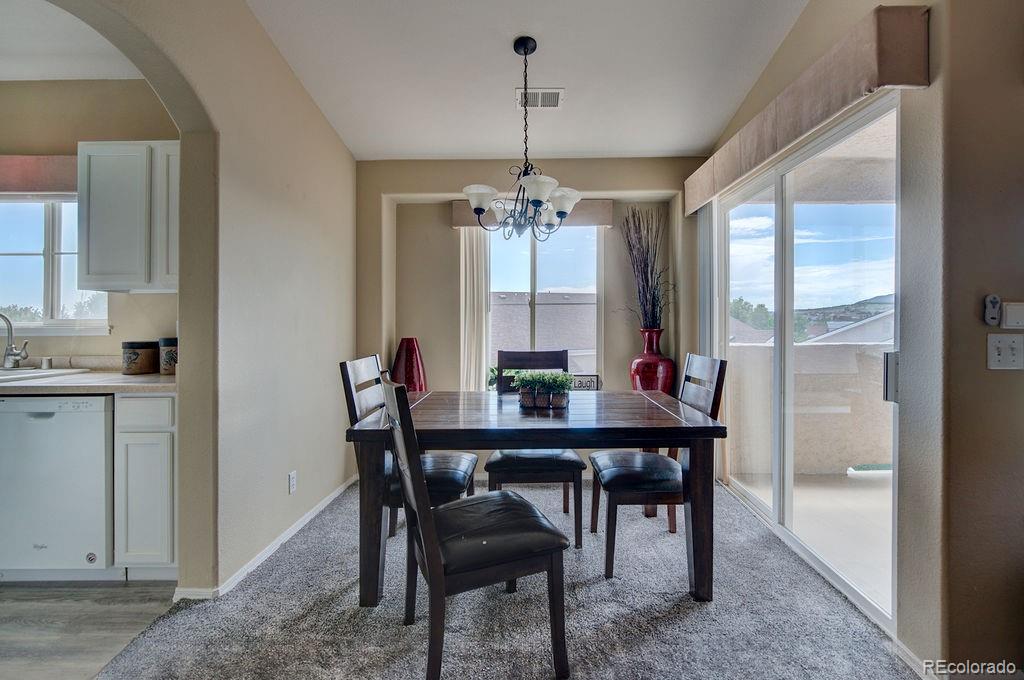 3875 Strawberry Field Grove Colorado Springs, CO 80906 - Photo 23 of 50 a view of a dining room with furniture window and outside view