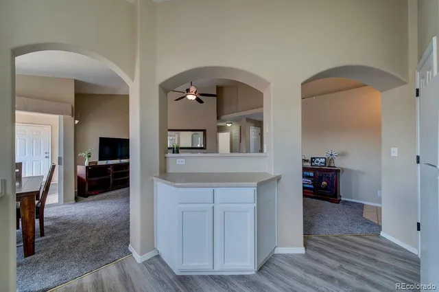 a living room with furniture and a wooden floor