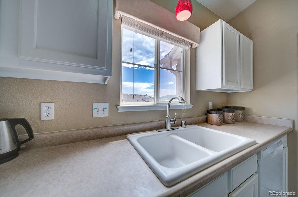 3875 Strawberry Field Grove Colorado Springs, CO 80906 - Photo 39 of 50 a kitchen with a sink and a window