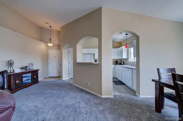 a large kitchen with kitchen island a large window in it