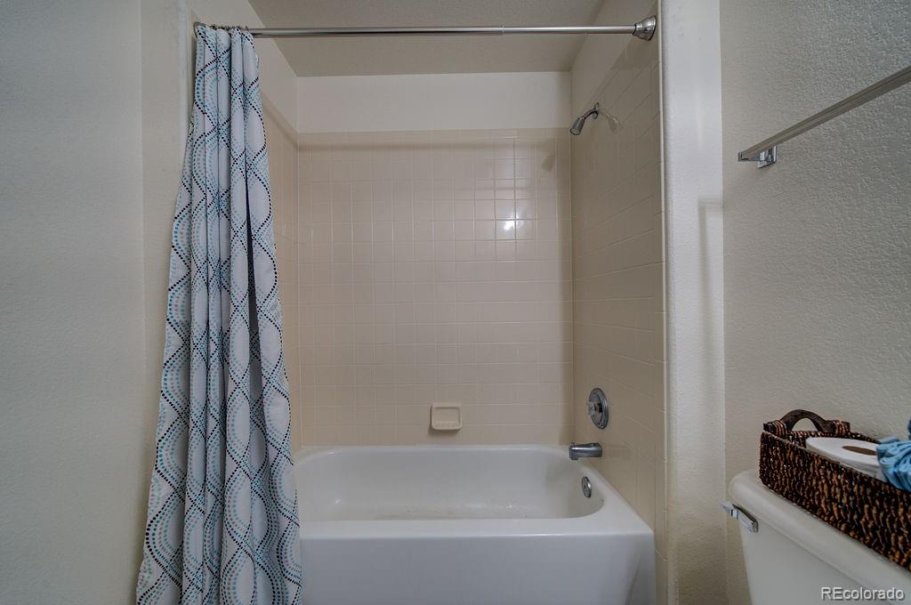 3875 Strawberry Field Grove Colorado Springs, CO 80906 - Photo 46 of 50 a bathroom with a bathtub and a shower
