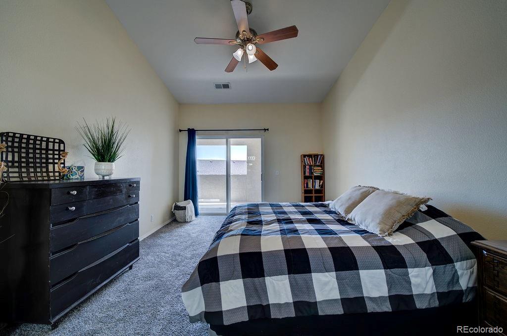 3875 Strawberry Field Grove Colorado Springs, CO 80906 - Photo 47 of 50 a bedroom with a bed and a chandelier