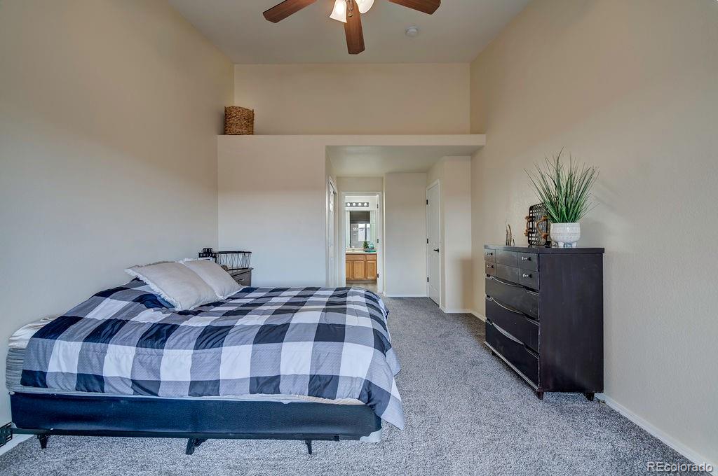 3875 Strawberry Field Grove Colorado Springs, CO 80906 - Photo 50 of 50 a bedroom with a bed and a chandelier