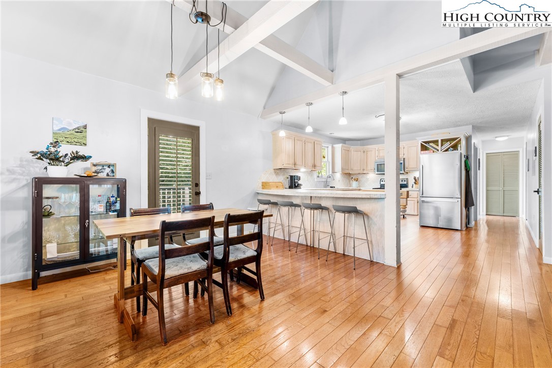 239 Deerfield Estates Road Boone, NC 28607 - Photo 11 of 45 a dining hall with stainless steel appliances kitchen island granite countertop wooden floor a dining table and chairs